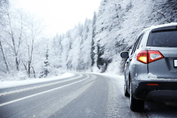 SUV Driving Safely on Snowy and Icy Road